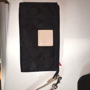 Black Coach wristlet with nude and red accents
